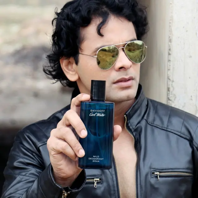 Perfume bottle held naturally in the outdoor scene